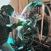 Mig welding steel part of 'Sea Fathoms Rising' in Lakewood, CO studio